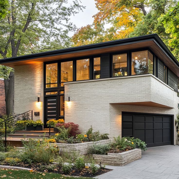 a modern house with large windows and landscaping