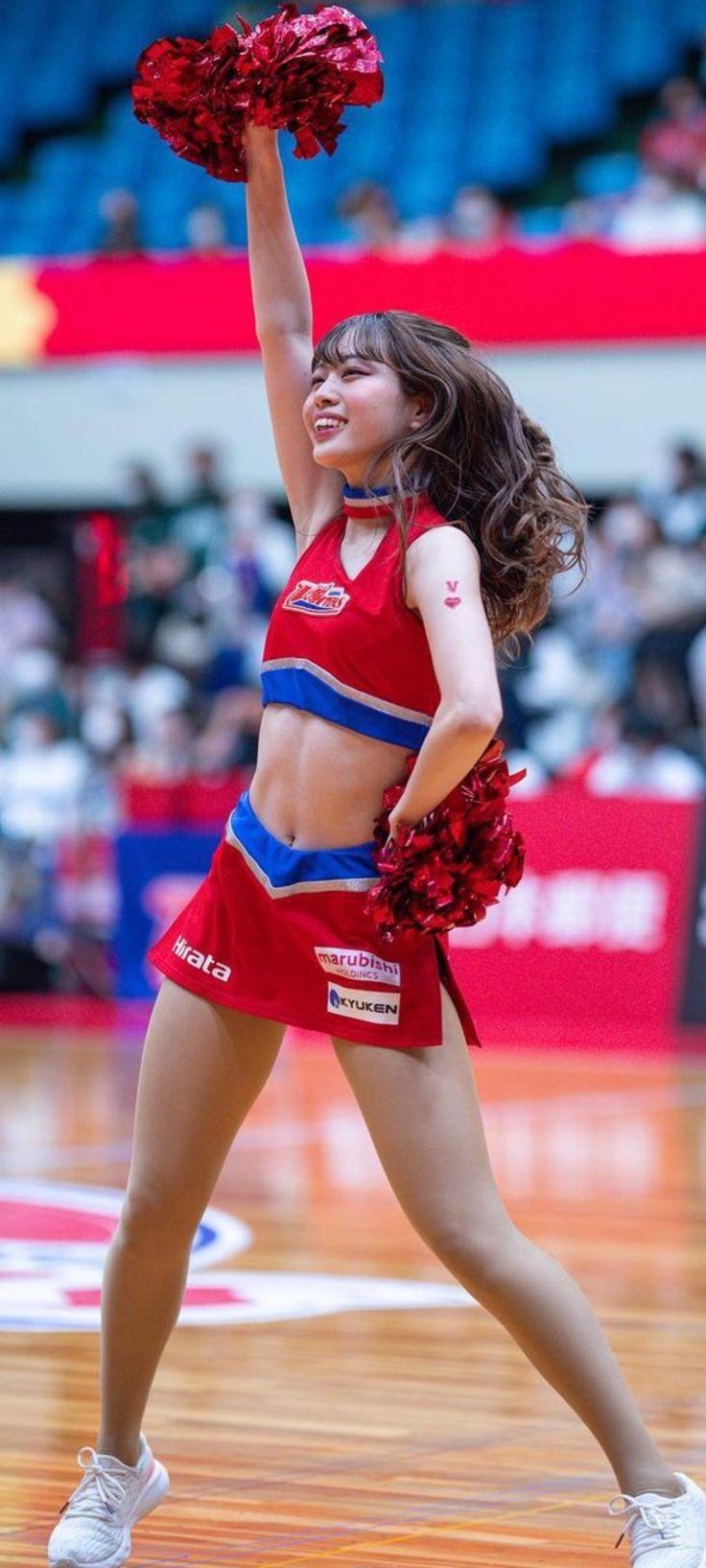 a cheerleader is performing on the court