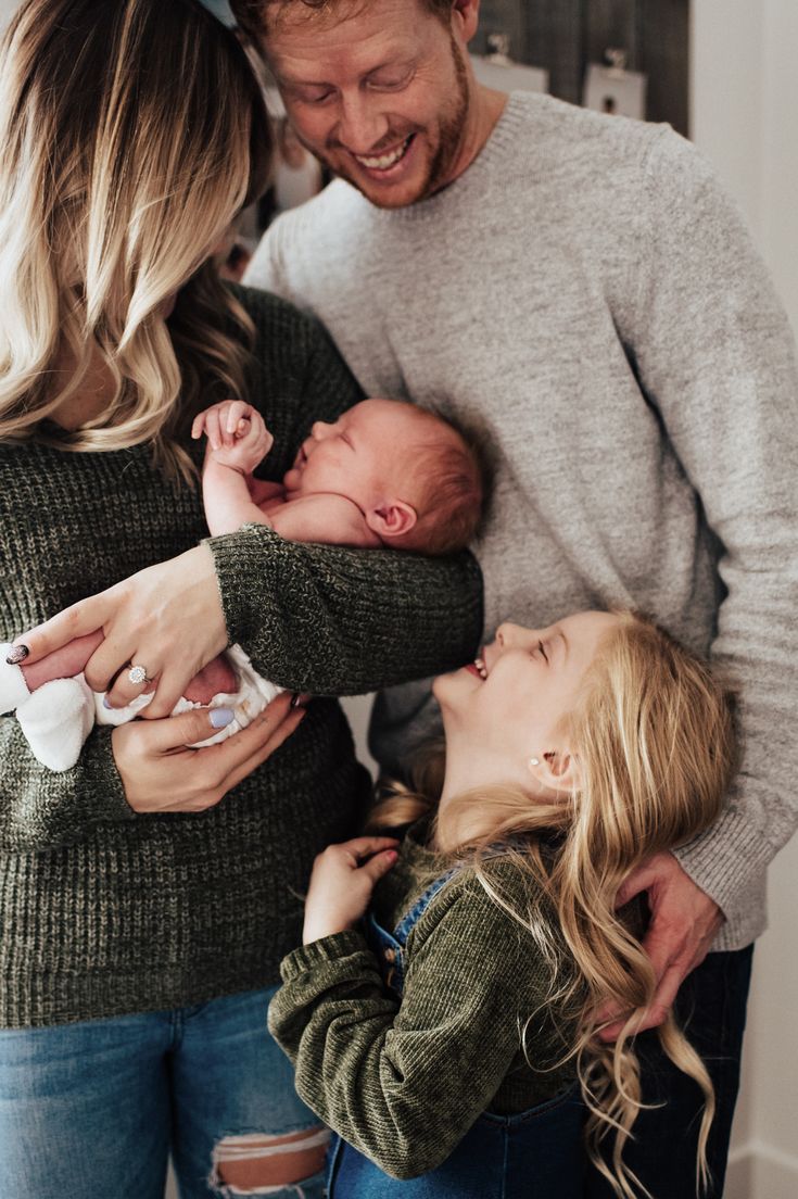 a man and woman are holding their newborn baby