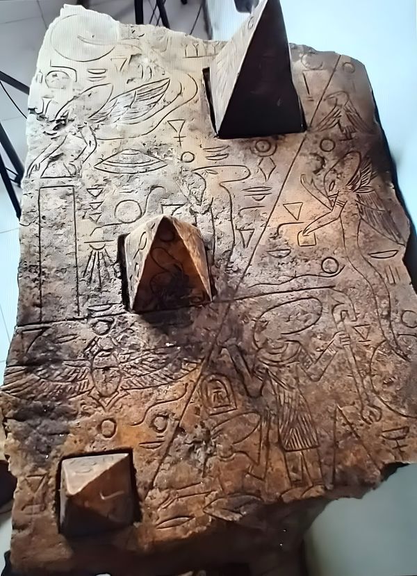 a piece of art that looks like it is made out of wood and has drawings on it