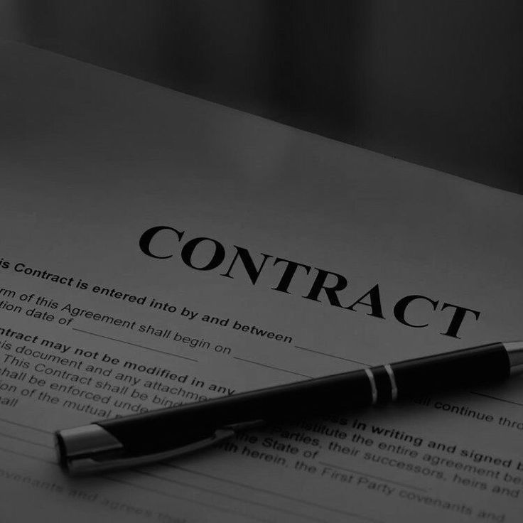 a pen sitting on top of a paper with the word contract written in it's center