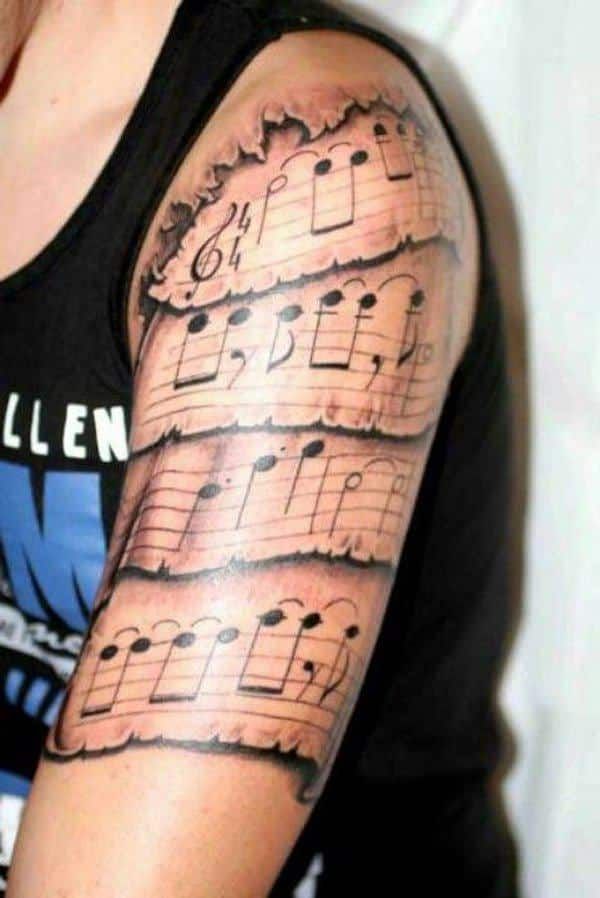 a man's arm with musical notes on it