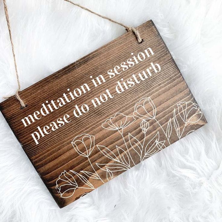 a wooden sign that says, with a client please have a seat on it hanging from a string