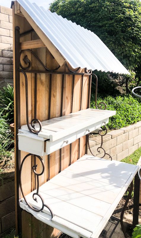 an outdoor shelf made out of wood and metal