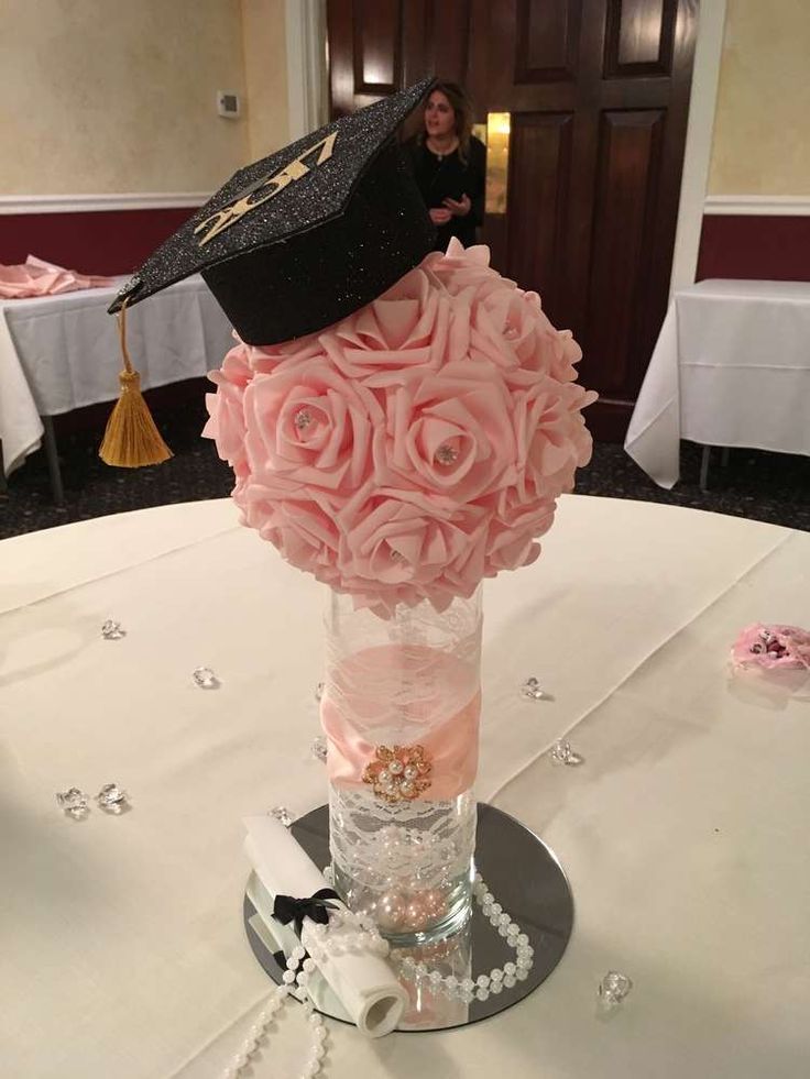 a bouquet of pink roses in a vase on top of a table