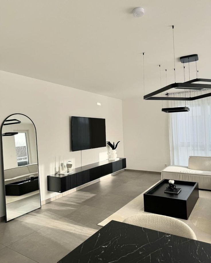 a modern living room with black and white furniture