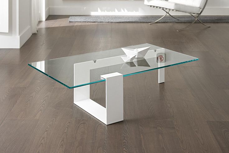 a glass table sitting on top of a hard wood floor