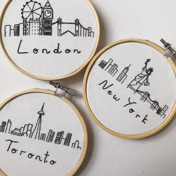 three embroidery hoops with the words london, new york and toronto written on them