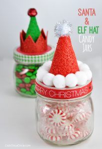 two jars filled with candy and santa's hat hats on top of each other