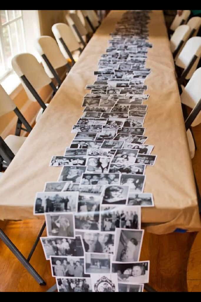 a long table topped with pictures and chairs