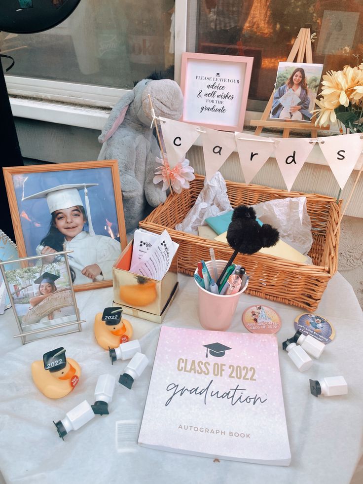 a table topped with pictures and other items next to a basket filled with stuff animals