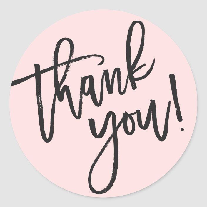 a round sticker with the words thank you in black ink on a pink background