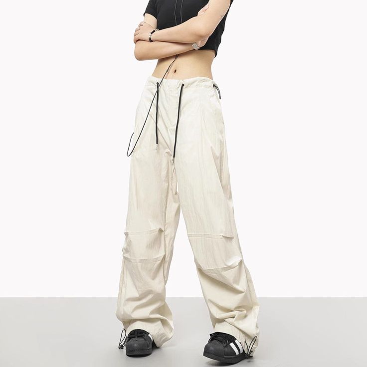 5ft 4''(163cm) tall, 97 lbs(44kg) weight and wearing a size M - Wide straight fit- Adjustable ankle- Adjustable waist- Drawstring- 6 colors Sporty Spring Pants, Sports Bottoms With Cargo Pockets And Wide Leg, Wide Leg Sports Bottoms With Cargo Pockets, Sporty Wide Leg Solid Cargo Pants, White Full-length Parachute Pants For Streetwear, White Full Length Parachute Pants For Streetwear, Urban White Wide Leg Parachute Pants, Urban White Wide-leg Parachute Pants, Full-length Beige Athleisure Pants