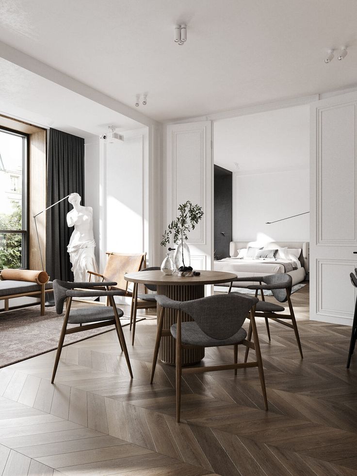 a living room filled with furniture and a wooden floor covered in hard wood planks