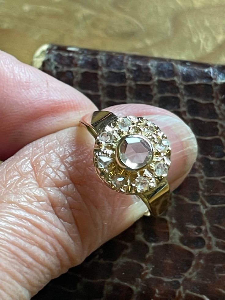 VICTORIAN Classic Clean Rose Cut diamond Halo ring from the late 1800's  Could be worn for a wedding, engagement or statement ring The diamonds are open backed, clean and white Hallmarked 14k Center diamond measures 4.75mm = .38ct estimate  8 surrounding diamonds rose cut 2.25mm .035ct. = .28ct. Estimated total weight .66ct = 2/3ct.  The ring is in EXCELLENT shape...it appears the last owner polished it up like new and perhaps put on a new shank Size 6.75-7 (inbetween) and easily resized  3.1 gr Hand Rings, Antique Boxes, Halo Diamond Ring, Halo Rings, Rose Cut Diamond, Rose Cut, Halo Diamond, Colored Diamonds, Halo