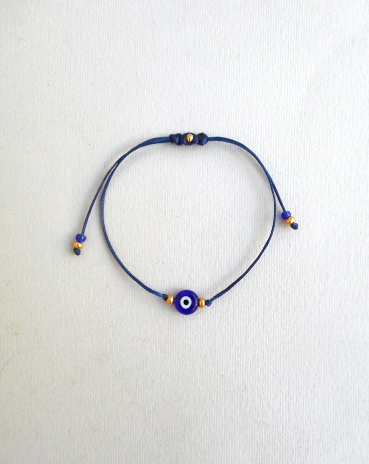 "Evil Eye Bracelet Gold beads Blue Evil Eye String Bracelet, Minimalist Lucky Bracelet Protection Greek jewelry Good luck gift Wish bracelet Lucky Rat Jewellery best selling Red string evil eye bracelet! -CHOOSING THE CORRECT SIZE- The bracelet in general is adjustable so it needs to be long enough to pass over someone's wrist. So approximately the wrist sizes are(excluding the cords hanging): Kids : 5 to 5.5\" teens: 5.5 to 6\" Women: 6 to 7\" Men: 7 to 8\" This simple yet beautifull bracelet i Blue Beaded Spiritual Bracelets With Sliding Knot, Blue Spiritual Beaded Bracelets With Sliding Knot, Spiritual Blue Beaded Bracelets With Sliding Knot, Handmade Blue Evil Eye Bracelet For Friendship, Blue Adjustable Friendship Bracelets With Round Beads, Spiritual Handmade Blue Braided Bracelets, Blue Beaded Jewelry With Adjustable Cord, Adjustable Blue Spiritual Braided Bracelet, Blue Adjustable Cord Bracelet As A Gift