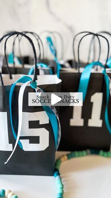 black and white paper bags with blue ribbon tied around the numbers one to five on them