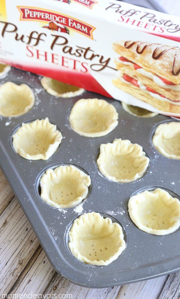 an uncooked muffin tin filled with puff pastry shells next to a box of pepperidge farms puff pastry sheets