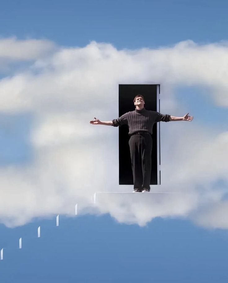 a man standing in the clouds with his arms out and hands outstretched above him as if he were floating