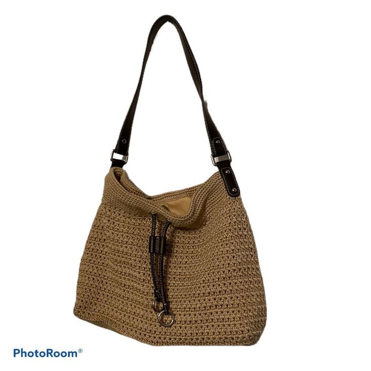 The Sak Tan Woven Bag With Brown Strap And Closure Strings, Silver-Toned Hardware New Without Tags Inside Pocket With Zipper Closure, And 3 Open Pockets For Phone Etc Approximate Meaurements Width 15", Height 11", Depth 3", Strap Height 12" Body $ Trim 100% Polyeurathane, Inside Lining 100% Nylon Casual Light Brown Hobo Bag With Leather Handles, Casual Beige Leather Crochet Bag, Casual Leather Hobo Bag For Beach, Casual Leather Crochet Bag For Everyday Use, Casual Leather Crochet Shopping Bag, Casual Leather Crochet Bag For Shopping, Light Brown Crochet Bag For Everyday Use, Tan Bag, Body Trim