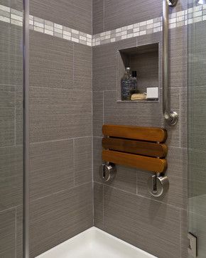 a bathroom with a glass shower door and wooden towel rack on the wall next to the bathtub