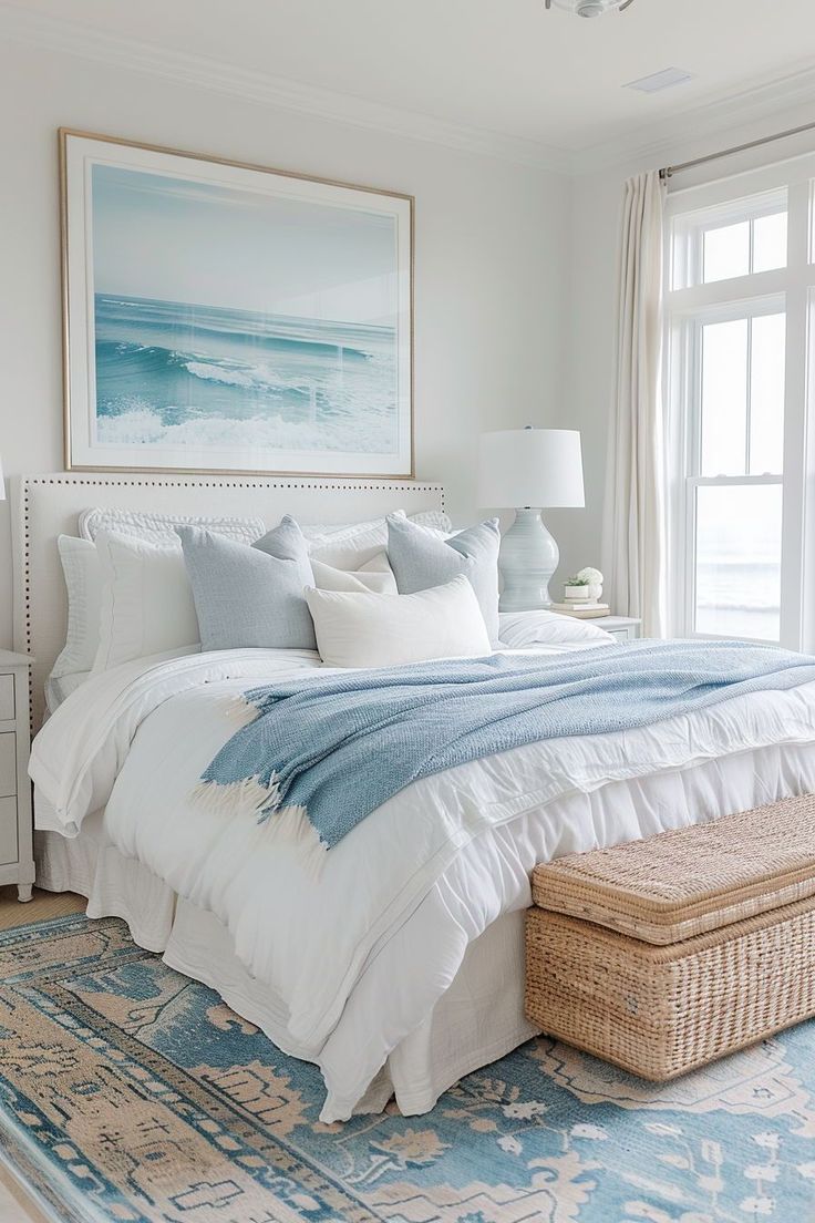 a bedroom with a large bed and blue rug in front of a window that has a painting on the wall above it