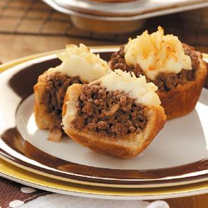 two pieces of bread with meat and mashed potatoes on it sitting on a plate