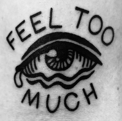 an eye with the words feel too much written on it's side ribcage