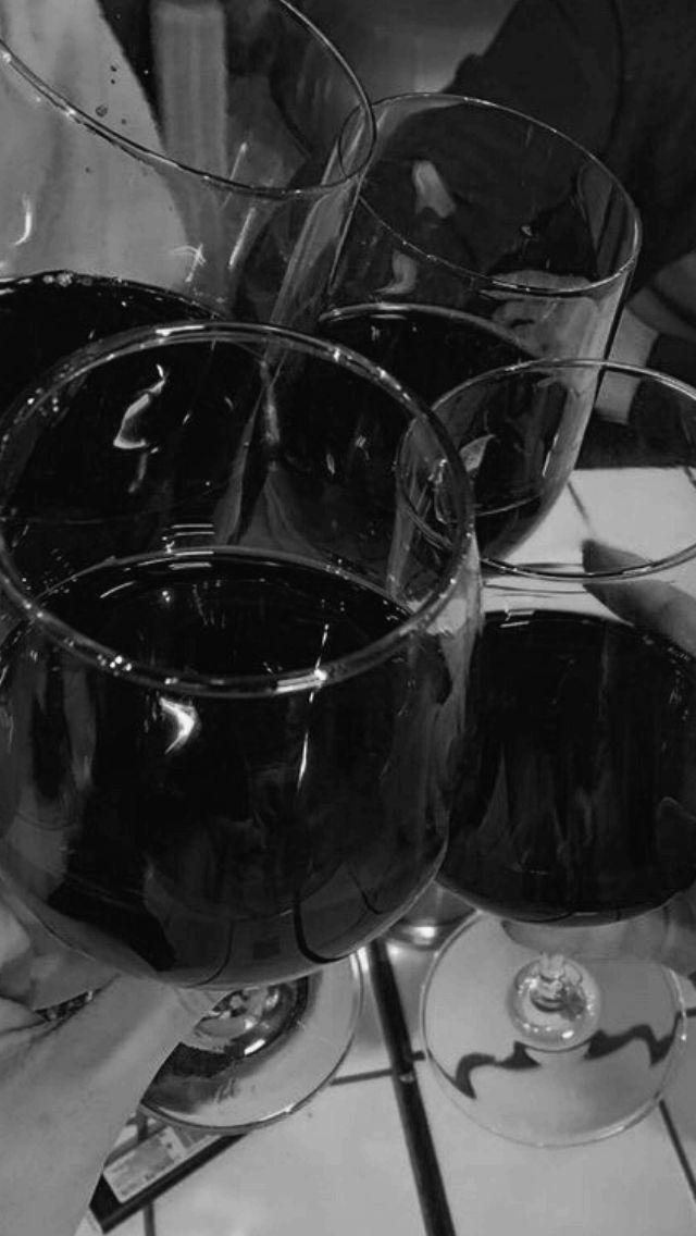 three wine glasses sitting on top of a table