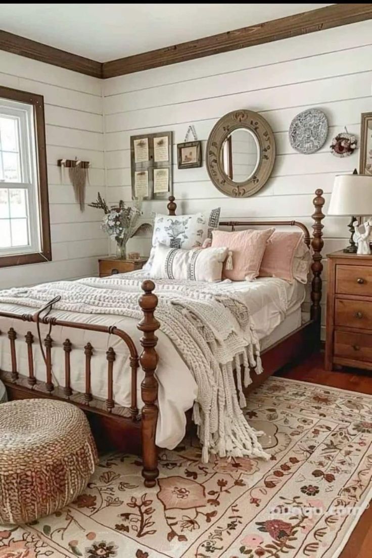 a bed room with a neatly made bed next to a window and a rug on the floor