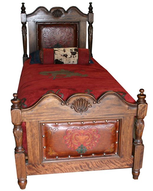 the bed is made up with red sheets and wooden headboard, along with decorative carvings