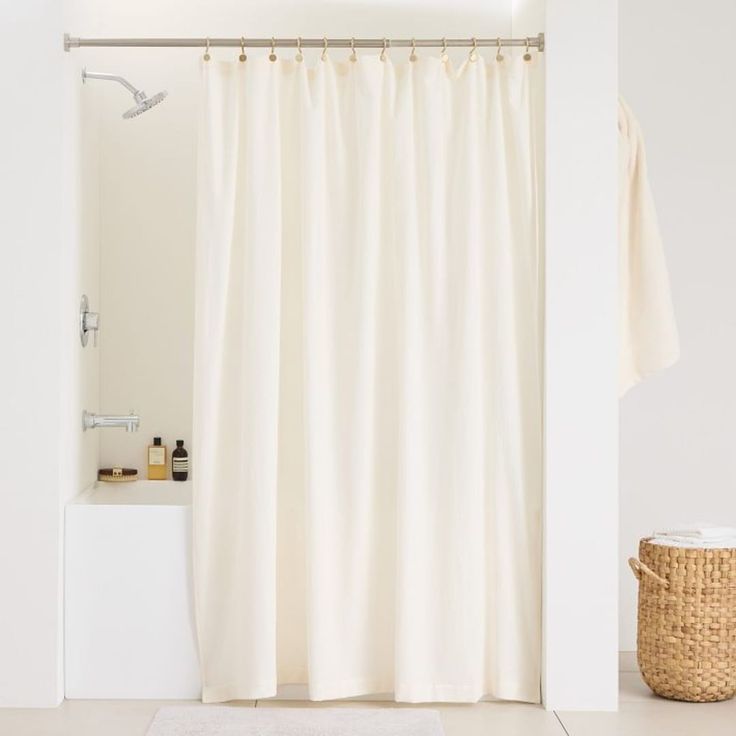 a bathroom with a white shower curtain next to a sink