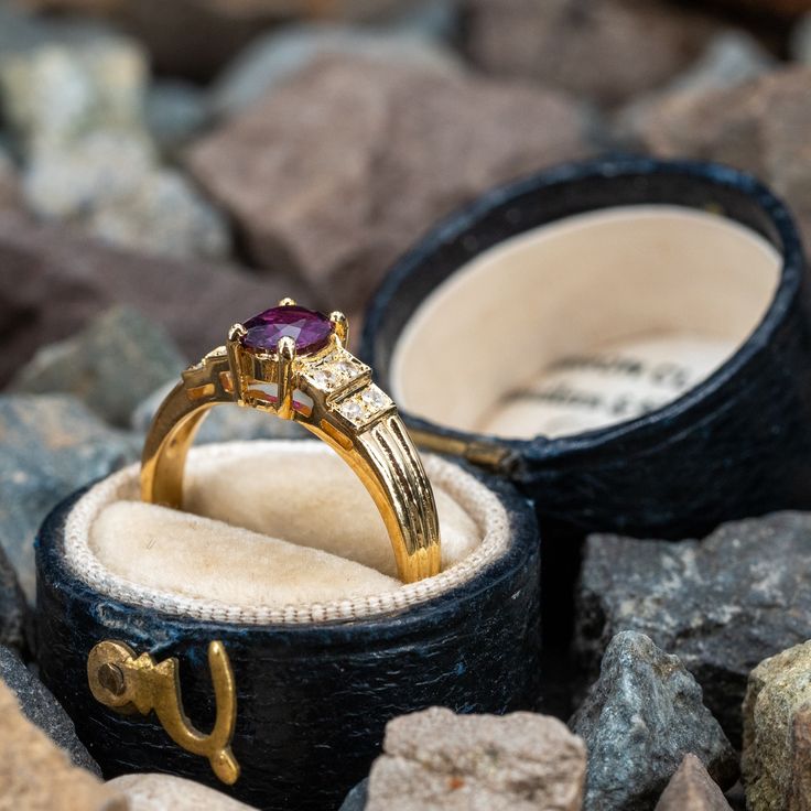 This pretty ring is centered with one (1) cushion cut natural ruby set into a four-prong setting. The shoulders of the ring are each accented with four (4), bead set, round brilliant cut diamonds. The ring measures 5.9mm at the top, rises 5.1mm above the finger, tapering to 2.1mm wide and 0.7mm thick at the base of the shank. This ring is currently a size 6. There is a tiny nick on the ruby but nothing noticeable that distracts from its beauty. Luxury Ruby Ring With Round Stone, Luxury Ruby Ring With Round Cut Gemstone, Luxury Ruby Rings With Gemstone Accents, Luxury Ruby Birthstone Ring For Wedding, Luxury 14k Gold Ruby Ring With Gemstone Accents, Luxury Ruby Ring With Gemstone Accents, Luxury Ruby Ring With Gemstone Accents For Anniversary, Elegant Cushion Cut Ruby Promise Ring, Classic Ruby Ring With Diamond Accent Stones