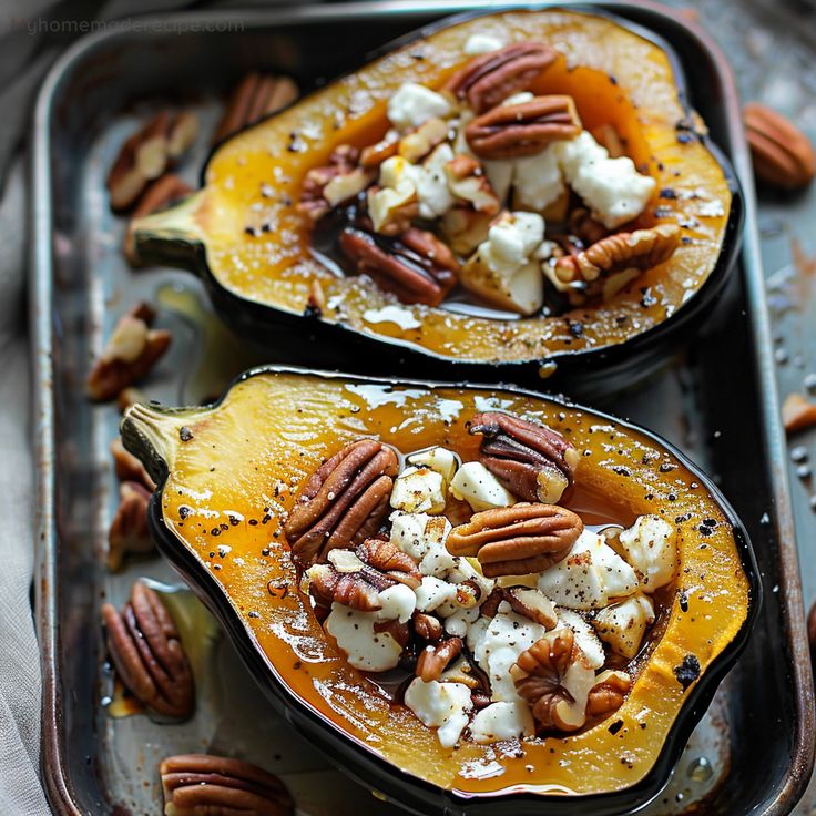 two acorns with pecans, cheese and nuts on a baking sheet for serving