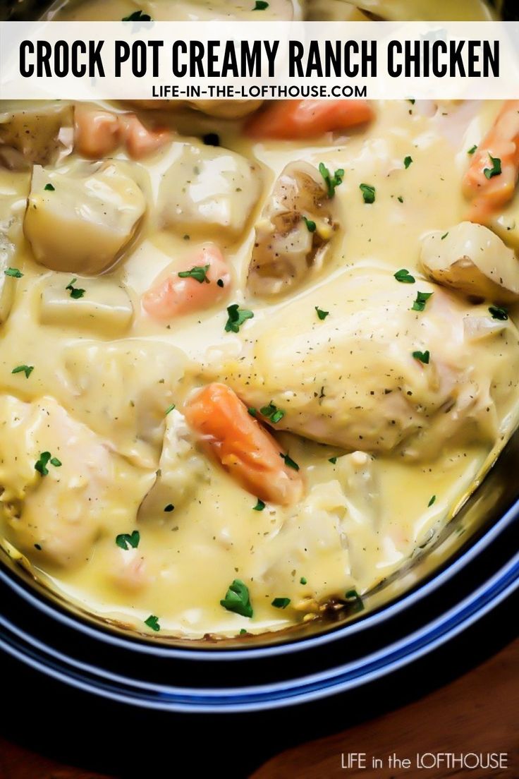 crock pot creamy ranch chicken with carrots and potatoes in a white broth