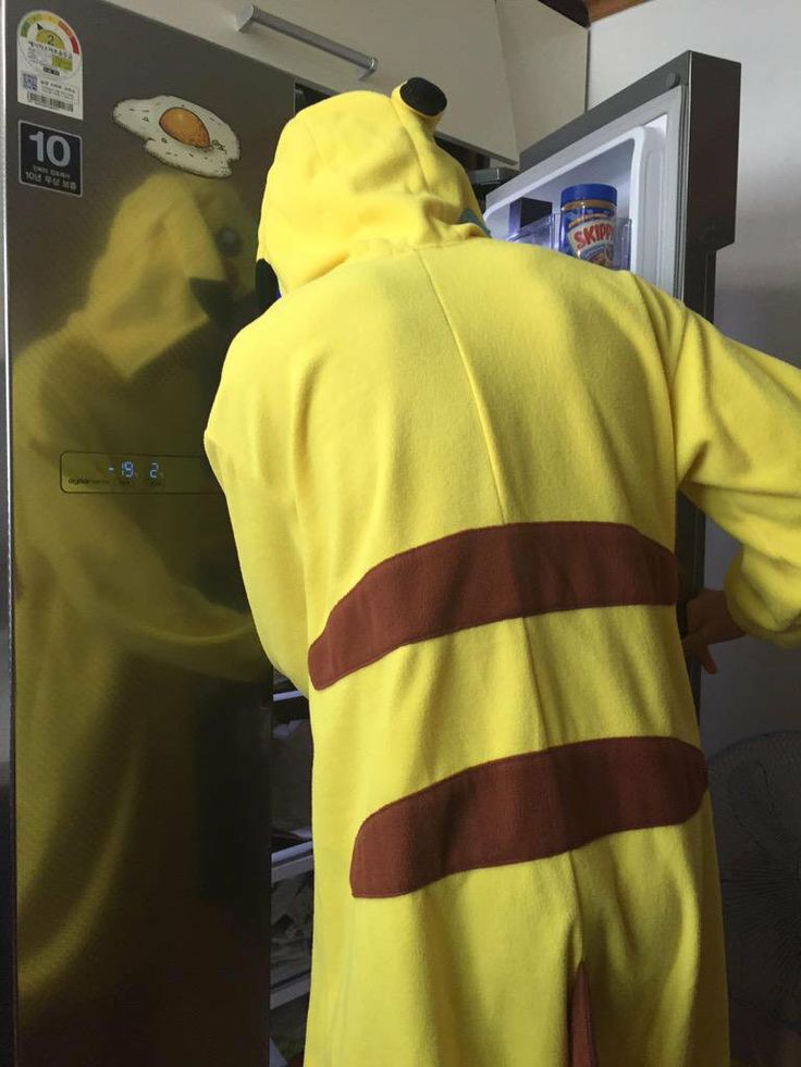 a person in a yellow costume standing next to an open refrigerator