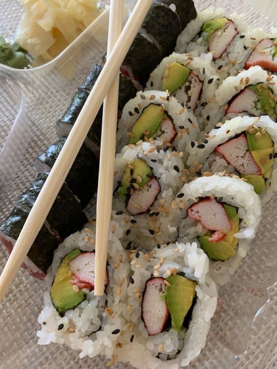 sushi and chopsticks on a clear plate