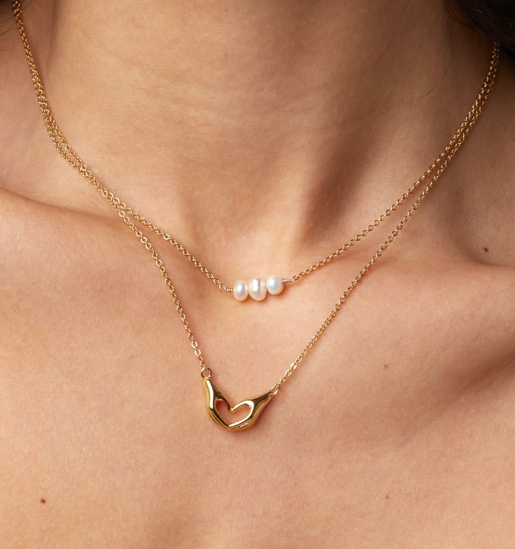 A stunning trio of mini pearls on dainty gold chain. We love this pearl choker as an everyday piece for your perfect chunky necklace stack. The adjustable length of 15"-17" makes it easy to layer to wear this at 15" as a choker or wear it longer at 17" near the collarbone.
Pearl: approximately 4mm | Adjustable length: 15" - 17" Trendy Adjustable Choker Pearl Necklace, Trendy Gold Pearl Choker, Trendy Gold Pearl Choker Necklace, Chic Pearl Chain Choker As Gift, Trendy Everyday Pearl Necklace With Adjustable Chain, Trendy Gold Pearl Charm Necklaces, Chic Gold Pearl Choker, Trendy Pearl Jewelry With Delicate Chain, Trendy Pearl Necklace With Delicate Chain