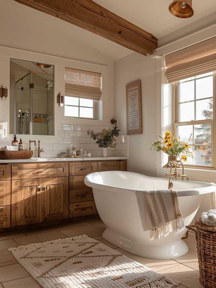 a bath tub sitting next to a window in a bathroom under two windows with sun shining through them