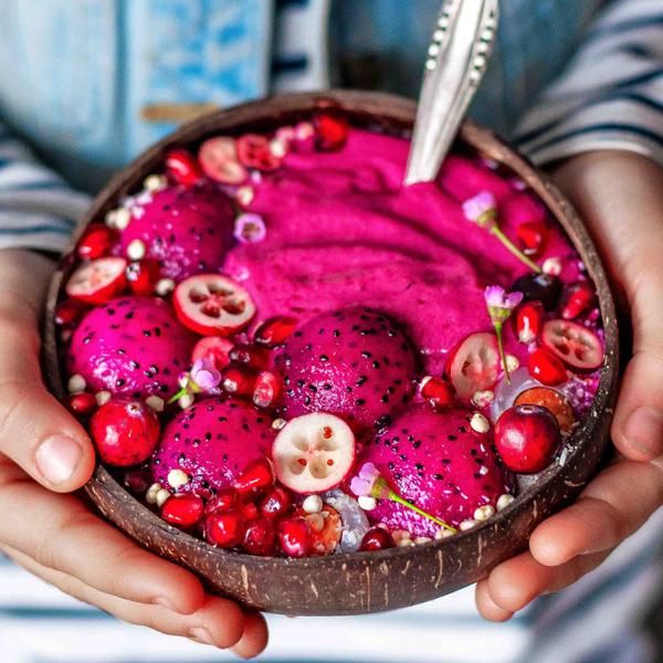 a person holding a bowl filled with fruit