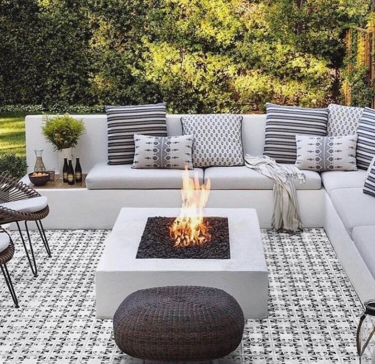 a white couch sitting next to a fire pit