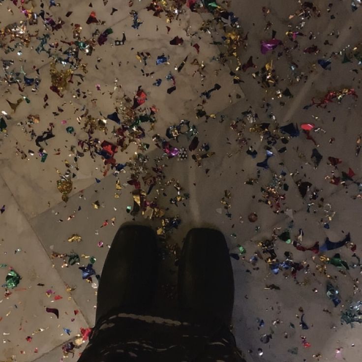 a person standing on top of a floor covered in confetti