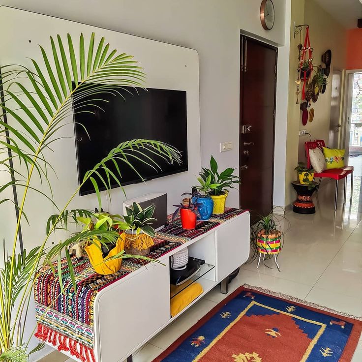 a living room filled with furniture and plants