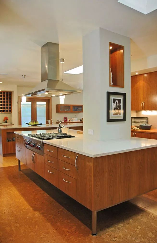 a large kitchen with an island in the middle