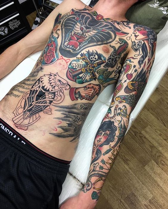 a man laying on top of a bed covered in tattoos