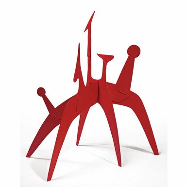 two red sculptures sitting next to each other on top of a white surface with one standing up