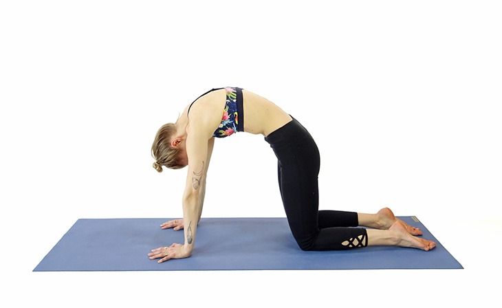 a woman is doing yoga on a blue mat