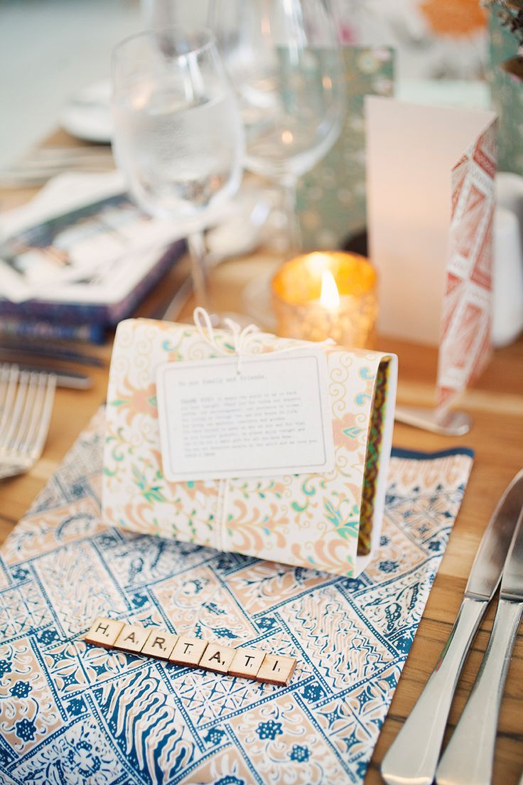 a place setting with wine glasses, silverware and napkins