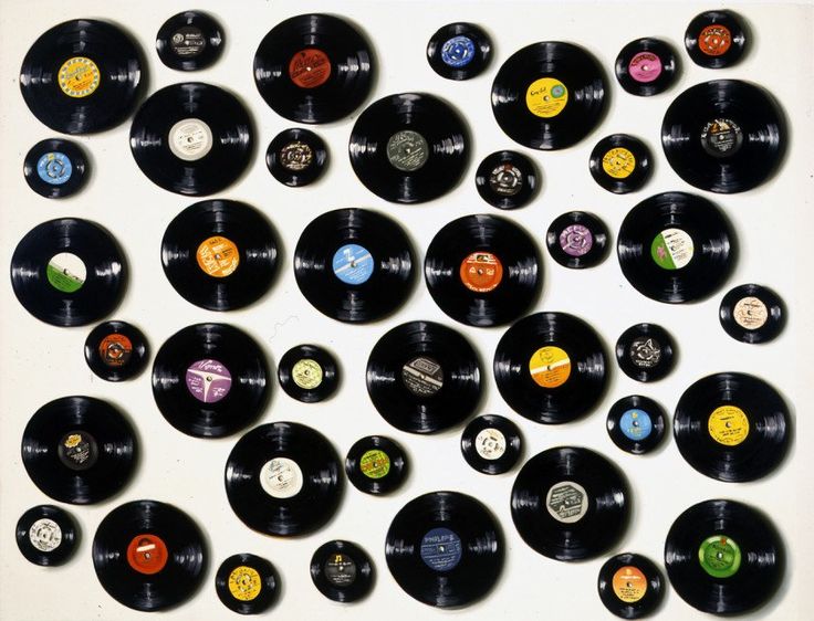 an old record wall with many different colored records on it