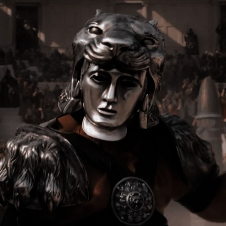 a statue of a roman soldier in front of a large group of people wearing helmets and armor